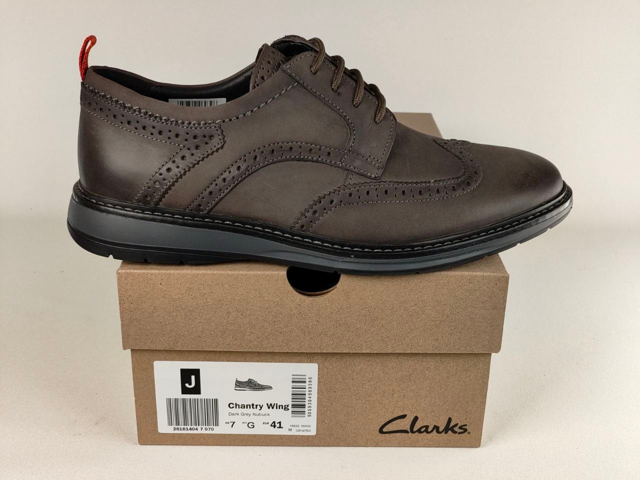 Brown leather shoe on a Clarks box with a beige background