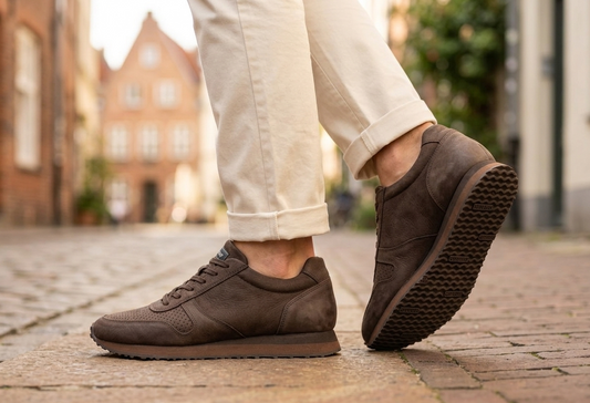Sebago Jude NBK dark brown shoes worn on a cobblestone street with blurred background