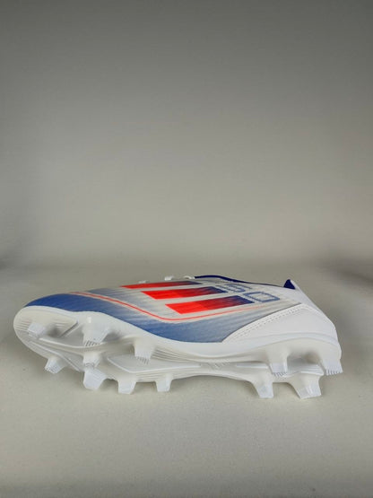 White Adidas F50 Club FxG cleat with red and blue design on a gray background - Side & Sole view @runinrain