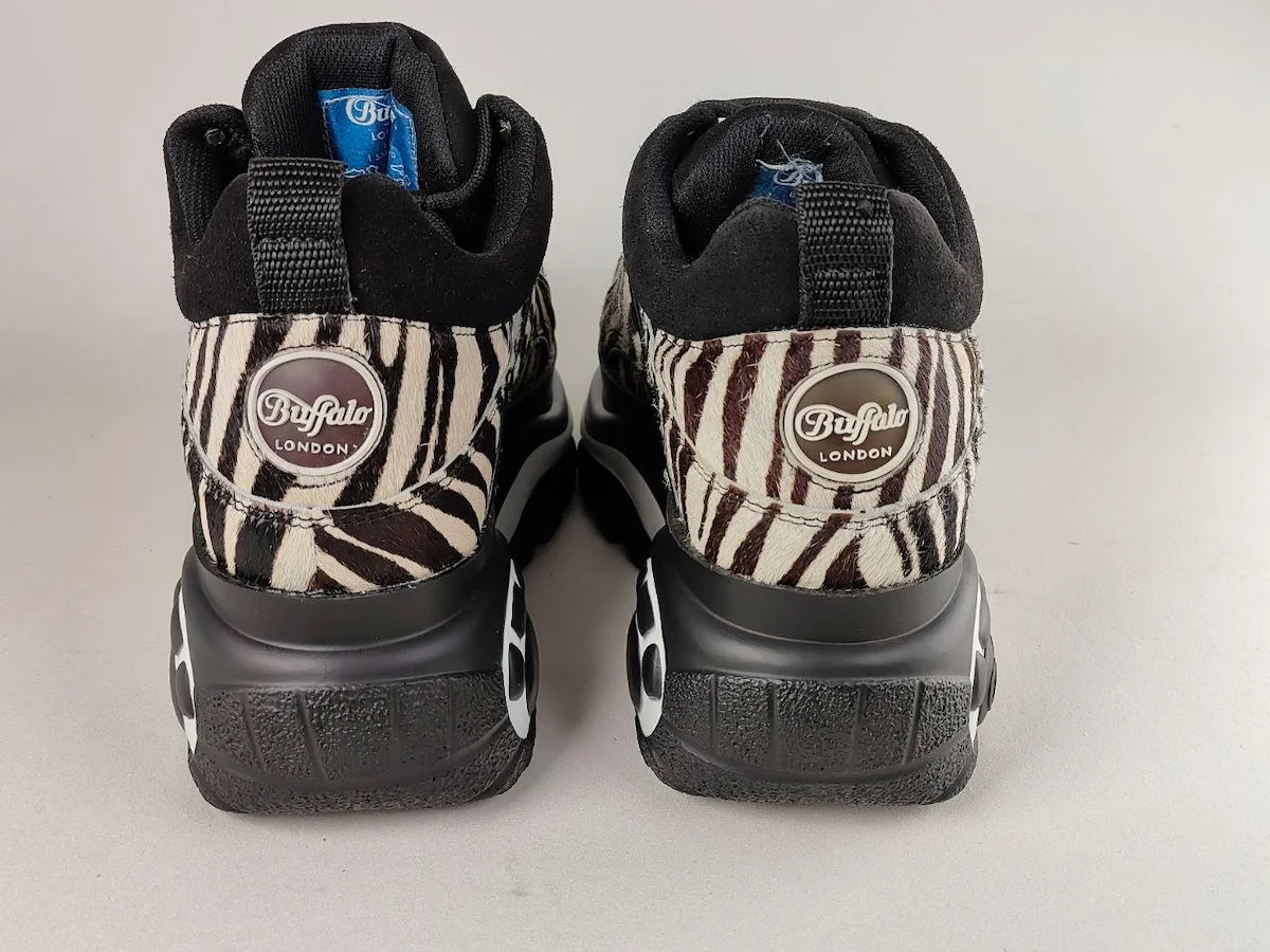 Pair of Buffalo London 1339-14 2.0 Zebra Platform Sneakers soles with 'Buffalo London' branding on a light gray background - rear view @runinrain