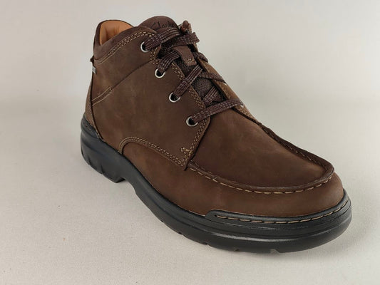 Brown leather shoe on a light gray background