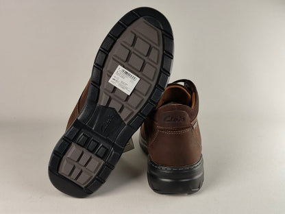 Brown shoes with black soles on a light gray background