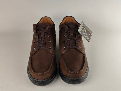 Pair of brown leather shoes with a GORE-TEX tag on a white background