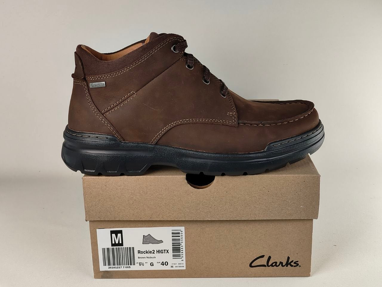 Brown leather shoe on a Clarks box with a beige background