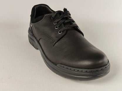 Black leather shoe on a light gray background