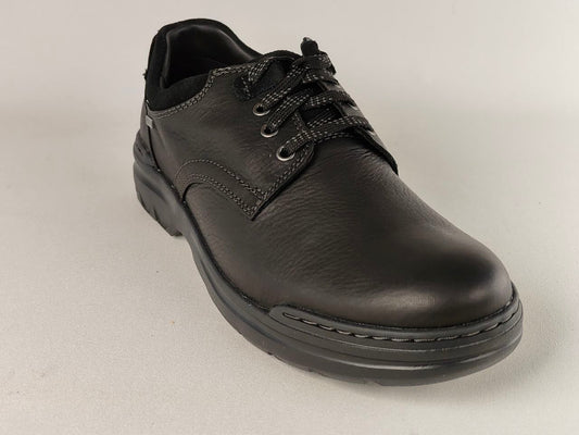 Black leather shoe on a light gray background