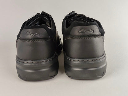 Pair of black Clarks shoes on a light gray background