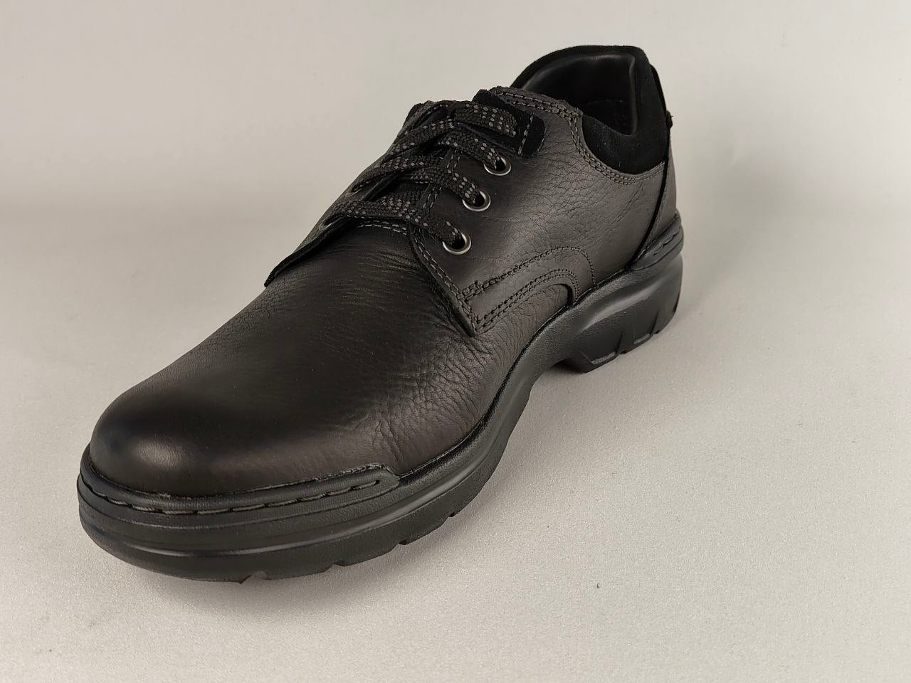 Black leather shoe on a light gray background
