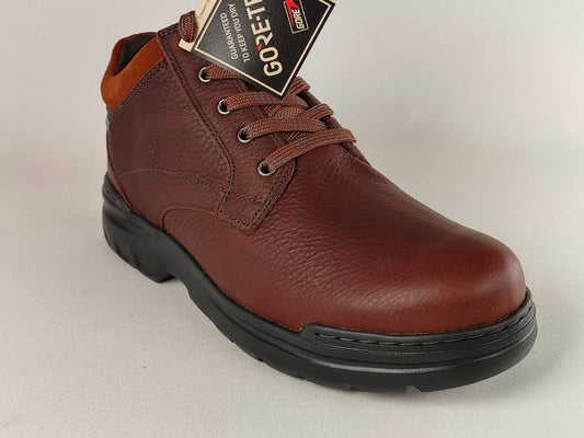 Brown leather shoe with a GORE-TEX label on a light gray background