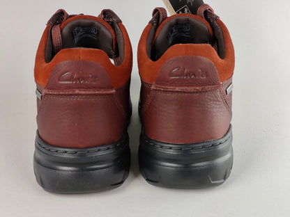 Pair of brown leather shoes with black soles on a light gray background