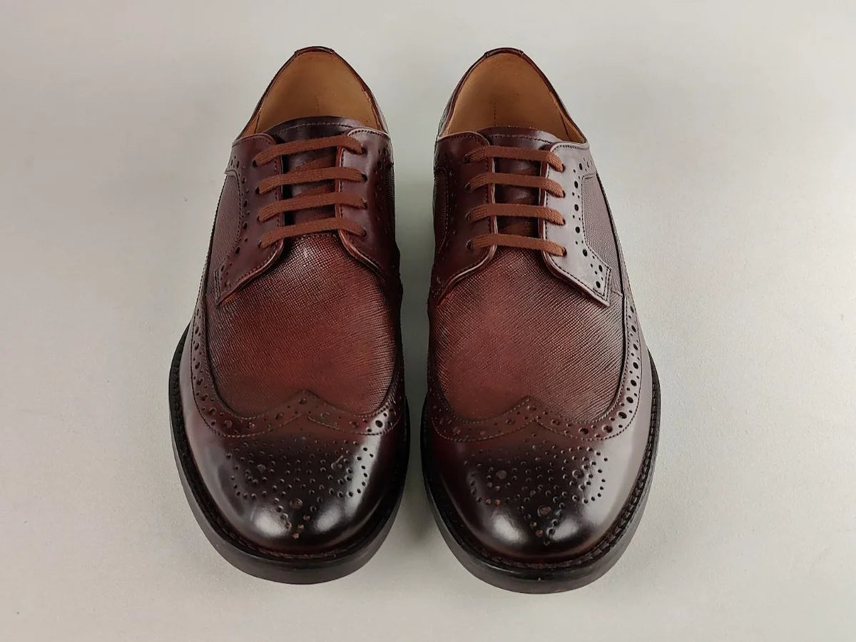 A pair of Clarks Ronnie Limit men's dark tan Full-Grain shoes on a light gray background - front view @runinrain