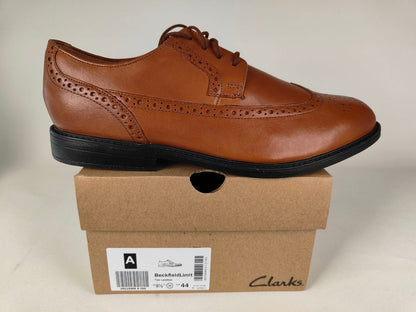 A Clarks Beckfield Limit Men's Tan Leather Wingtip Brogue shoe on a Clarks branded box on a white background - detail view @runinrain