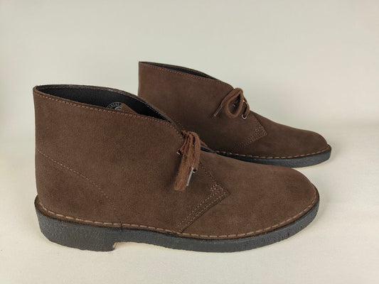 Pair of brown suede shoes on a light gray background