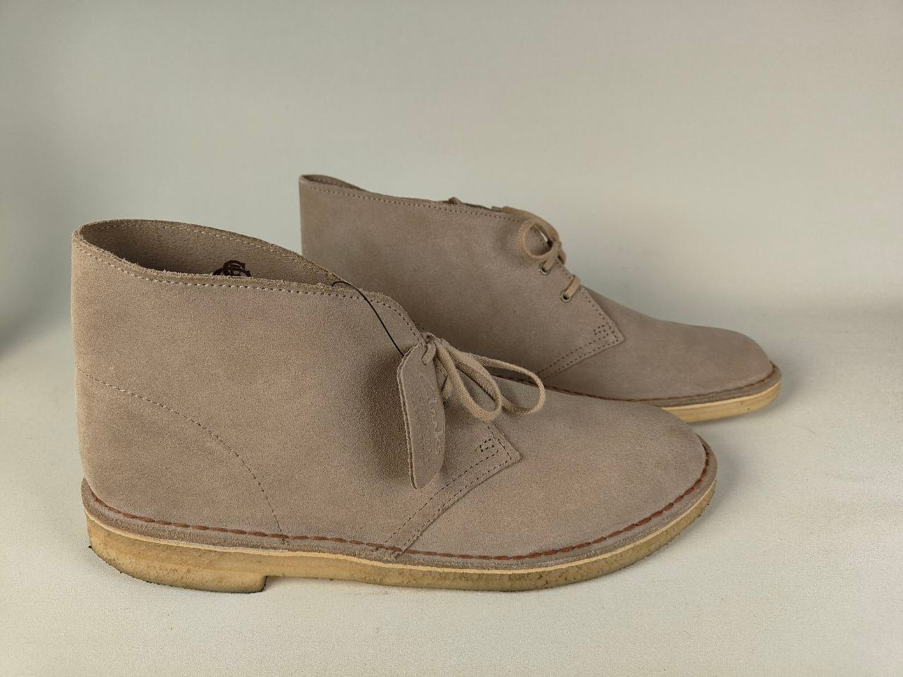 Pair of Clarks Originals Desert Boot Sand Steads Suede on a light gray background - Side view @runinrain