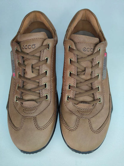 Pair of brown sneakers with 'ecco' branding on a light blue background