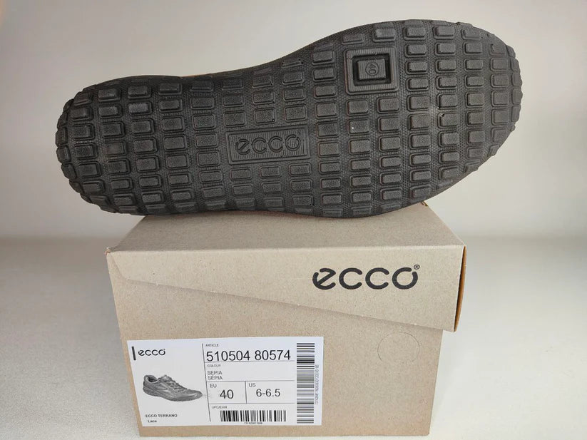 Ecco shoe with a black sole on a cardboard box with ECCO branding.