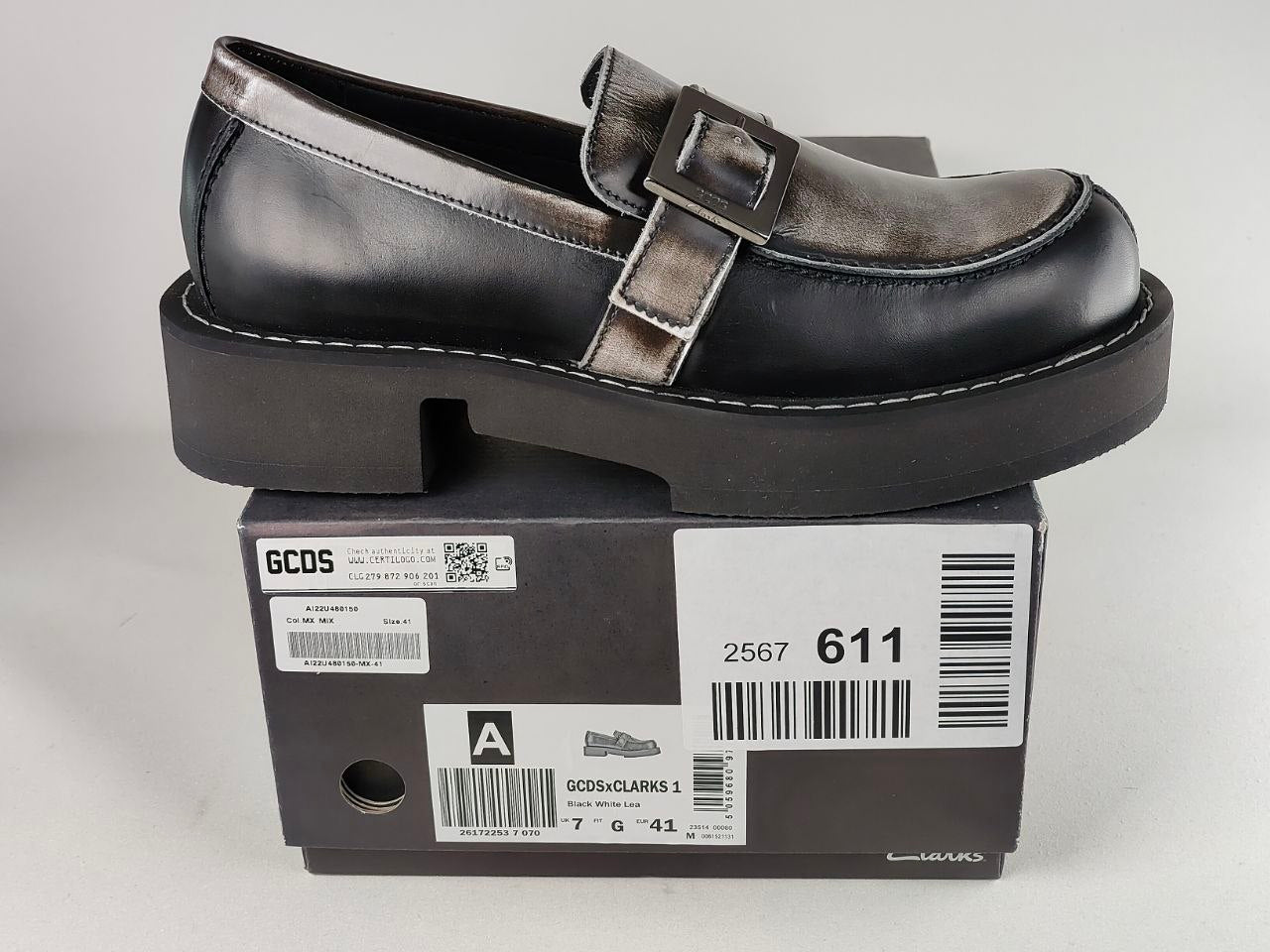 Black and white GCDS x Clarks 1 loafer shoe on top of a box with visible branding and product details - detail view @runinrain