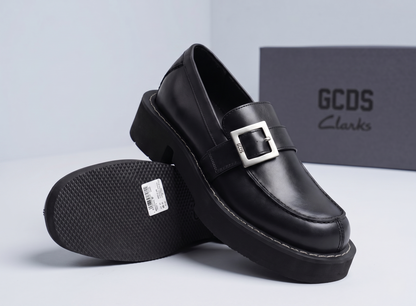 GCDS x Clarks 1 black leather loafers with silver buckle detail and chunky lug sole, displayed with GCDS box - brand shot @runinrain