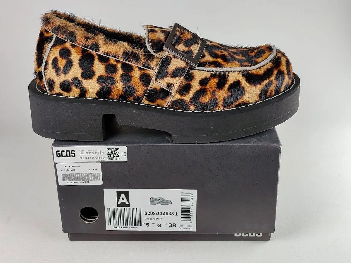 Leopard print loafers on top of a black box with 'GCDS' branding.