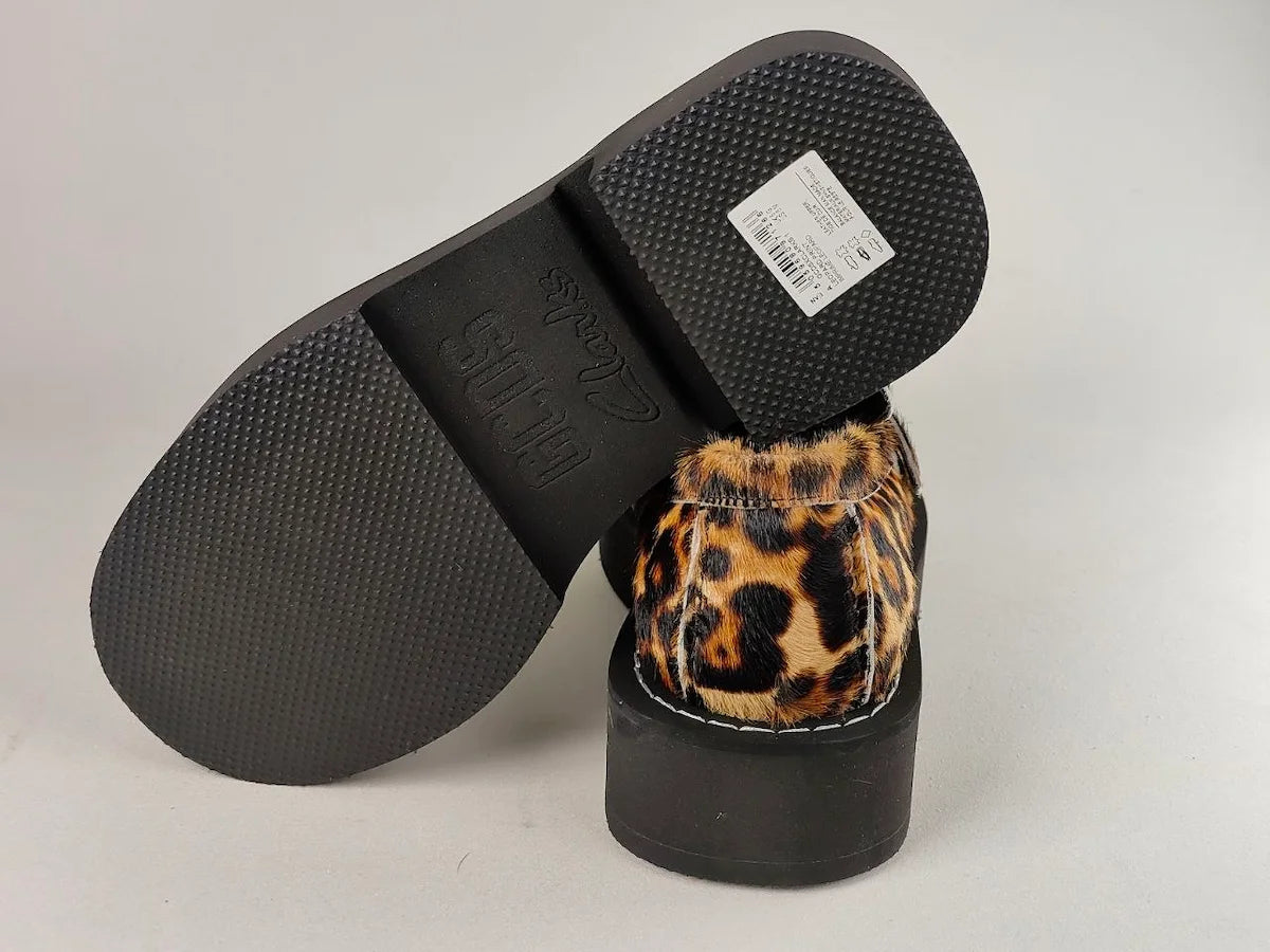 Black slide GCDS x Clarks 1 with leopard print interior on a light gray background