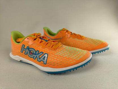 A pair of orange HOKA Cielo X 2 MD running shoes with blue soles on a gray background - 3/4 view