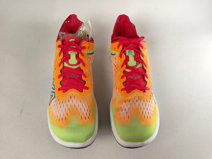 A pair of Hoka Cielo FlyX Carbon-Plated Track Spikes Solar Flare with red laces on a light gray background – Top View @RunInRain 