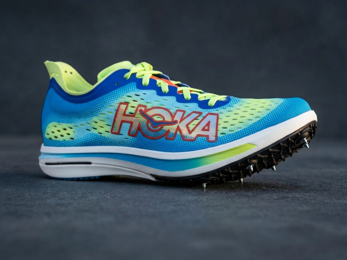 Hoka Cielo FlyX Carbon-Plated Track Spikes Cyan/Lime with Hoka branding on a dark background – Side View hero shot @RunInRain