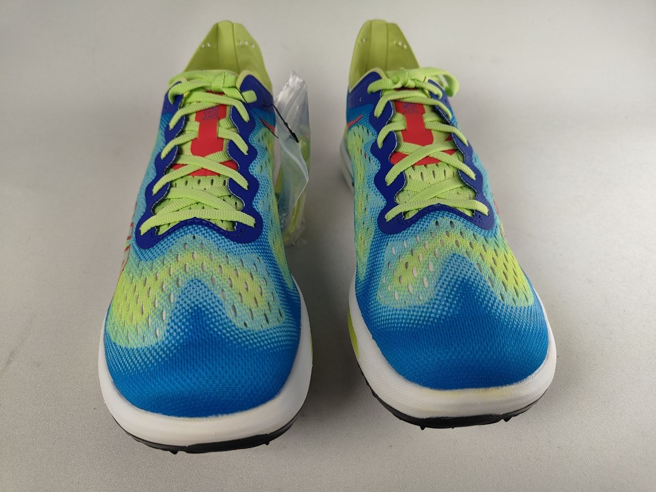 Pair of Hoka Cielo FlyX Carbon-Plated Track Spikes Cyan/Lime shoes on a light gray background – Front View @RunInRain 