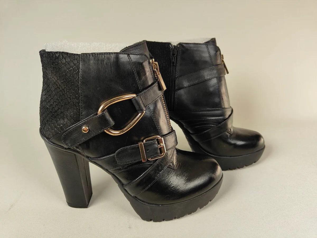 A pair of La Strada High-Heel Platform Boots Signature Gold Buckle Edition on a beige background - side view @runinrain