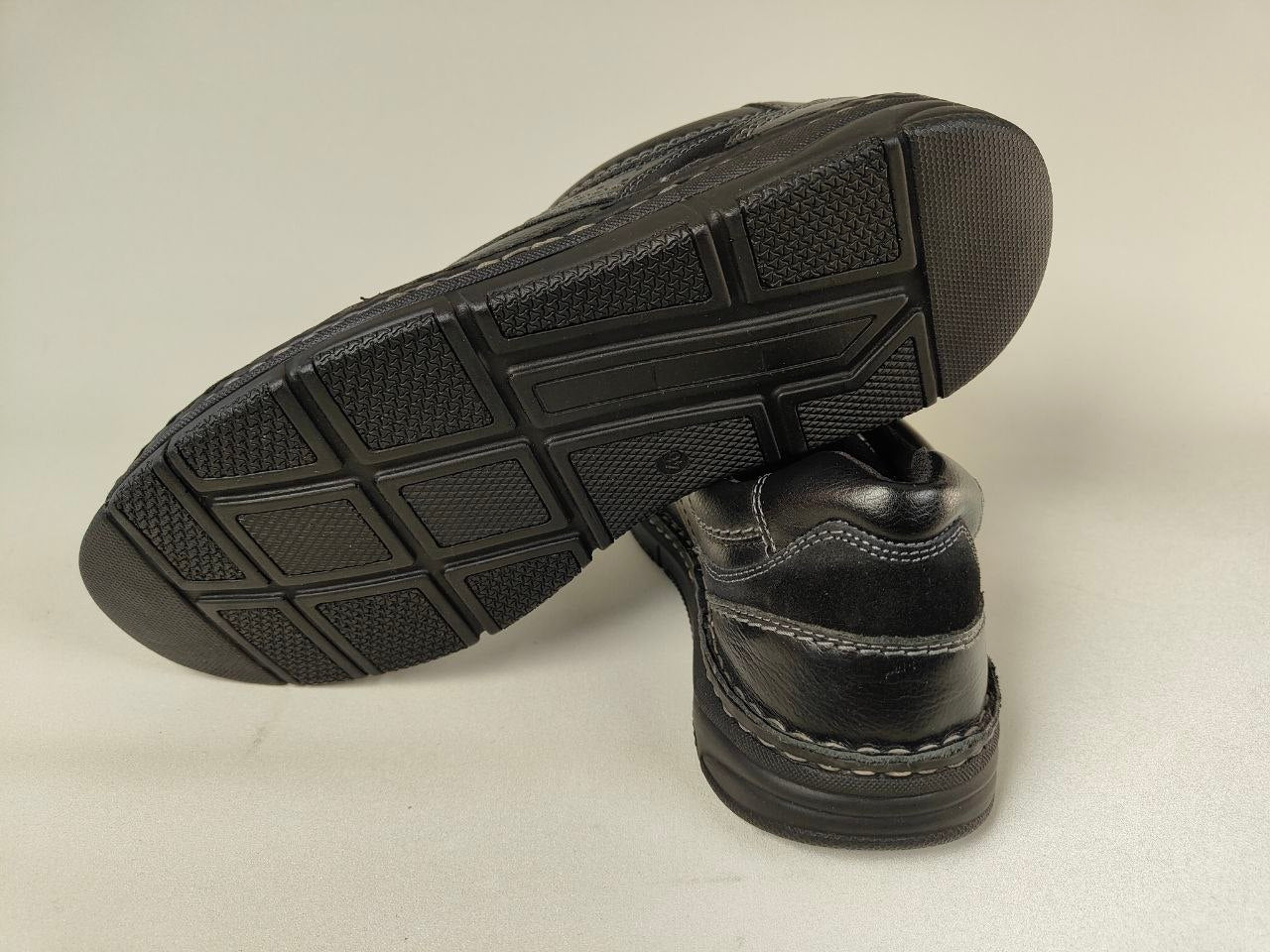 Black Orchard Anatomical Leather Loafers shoes with textured soles on a light gray background