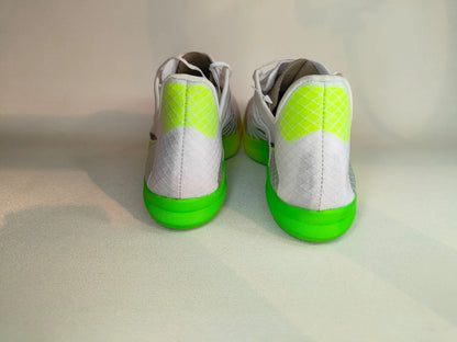 Pair of white Saucony Terminal VT with green soles on a light gray background - rear view @runinrain