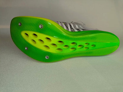 Green sole of Saucony Terminal VT with holes on a light gray background - sole view @runinrain