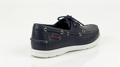 A navy blue Sebago Docksides Portland Women's Nautical Loafers shoe with white laces and a SEBAGO brand on a white background – Sole View @RunInRain