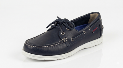 A navy blue Sebago Docksides Portland Women's Nautical Loafers shoe with white laces on a white background – 3q View @RunInRain