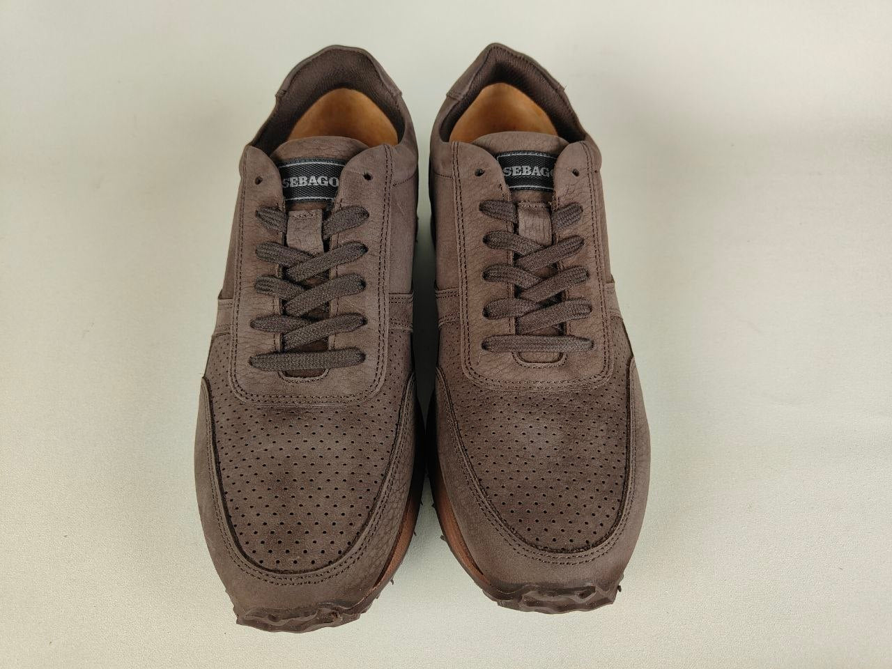 Pair of Sebago Jude NBK Dark Brown shoes on a light beige background